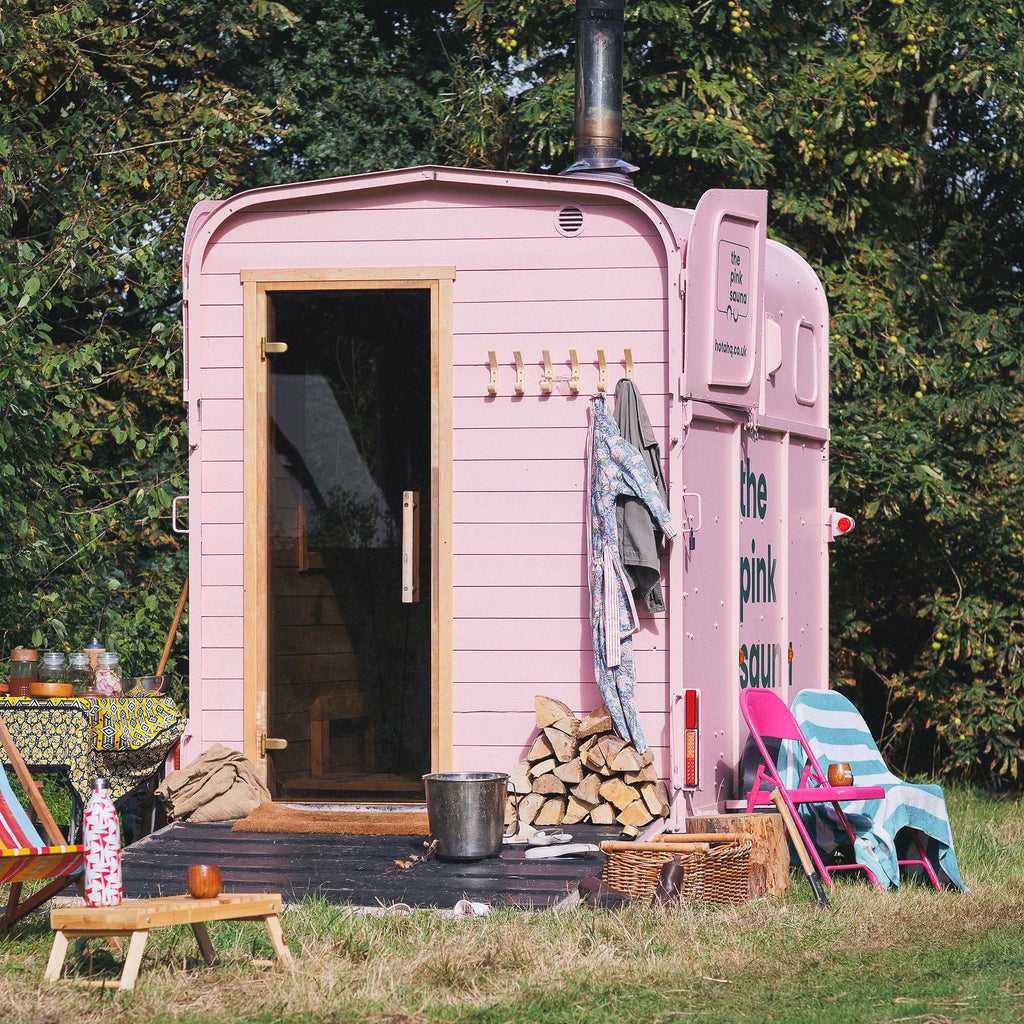 Pink sauna box in wild flower meadow